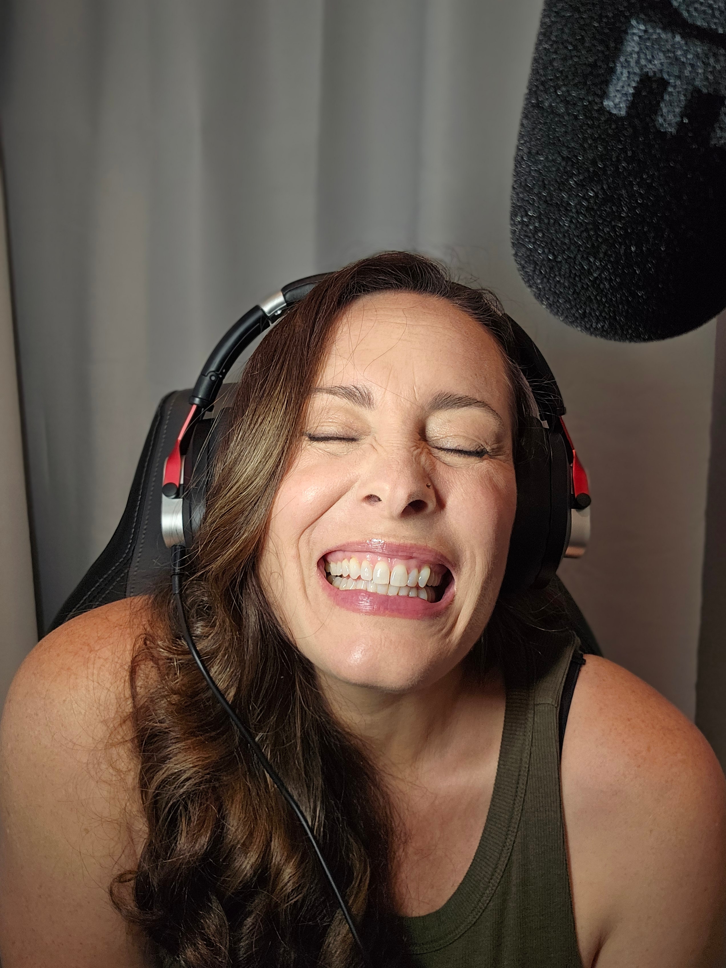 Carolyn Rose Miller laughing with headphones on in the studio